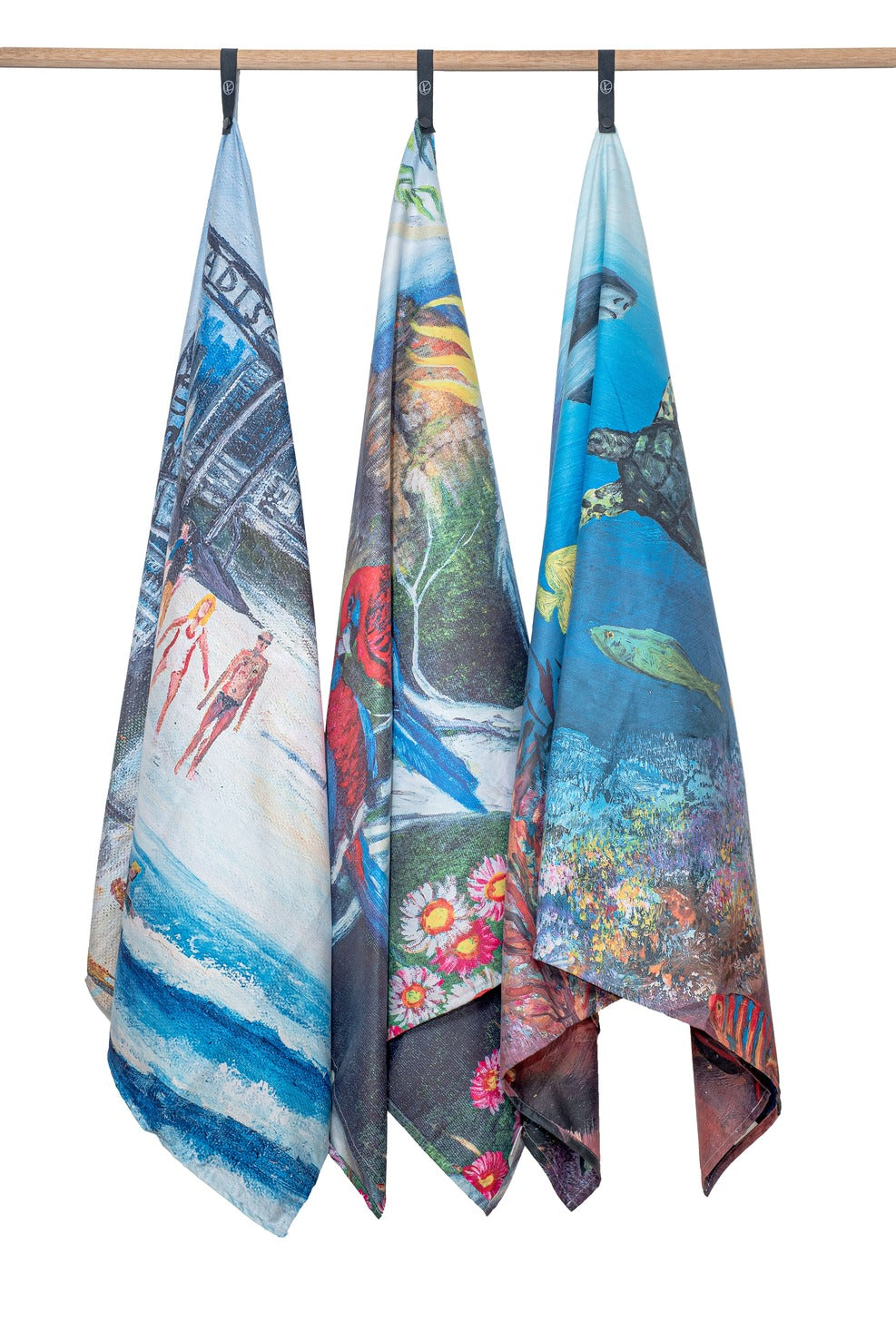 Surfers Paradise, Blue Mountains and The Great Barrier Reef microfibre artistic towels hanging. Large size, 170cm x 95cm, soft touch, compact and sand free beach towel. An Aussie-inspired art showcasing magnificent landmarks and the Aussie lifestyle.