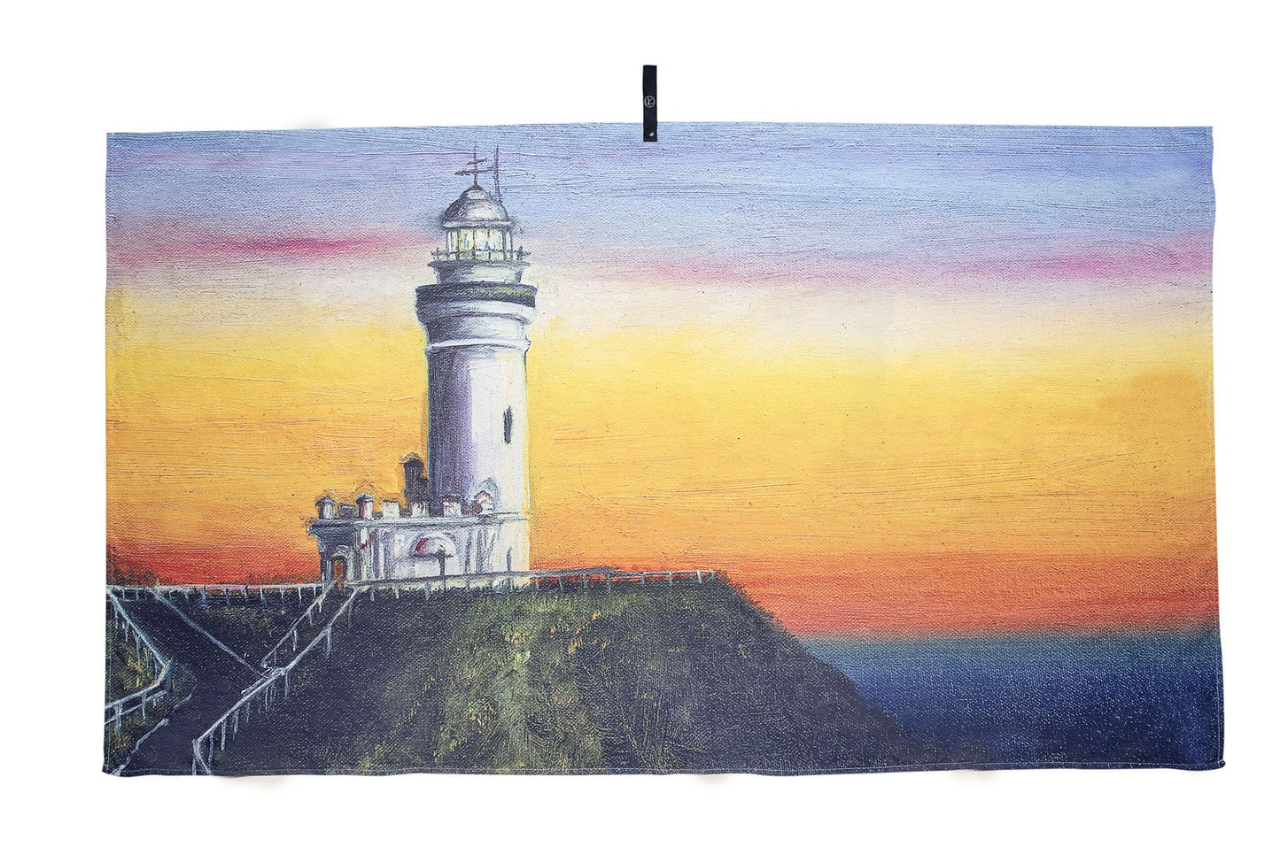 Byron Bay microfibre artistic towel. The towel shows Byron Bay’s famous Cape Byron Lighthouse on top of the cliff with its otherworldly Pacific Ocean view intense sunset yellow, pinkish and blue colors. An art inspired by the Byron’s unique atmosphere of nature and well-being. Large size, 170cm x 95cm, soft touch, compact and sand free beach towel. An Aussie-inspired art showcasing magnificent landmarks and the Aussie lifestyle.